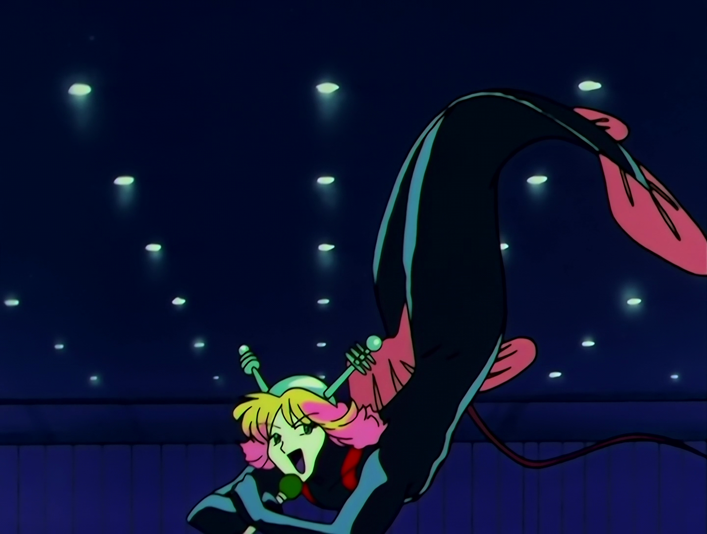 BiriBiri Yarou, a Lemures from Sailor Moon episode 160. He has light green skin and long, pink and yellow hair. He’s wearing a kind of black latex bodysuit that covers everything aside from his face, but he’s also a merman so maybe this is just his skin? He has a fish tail instead of feet, and pink fins. He’s wearing a metal helmet with antenna, holding a microphone, and kind of lounging in mid-air.